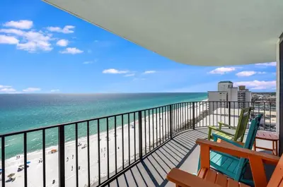 a balcony with two chairs and the beach at Watercrest 1510 - Timeless Memories Stunning views in Panama City Beach