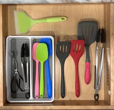 a drawer with utensils in a wooden box at Watercrest 1510 - Timeless Memories Stunning views in Panama City Beach