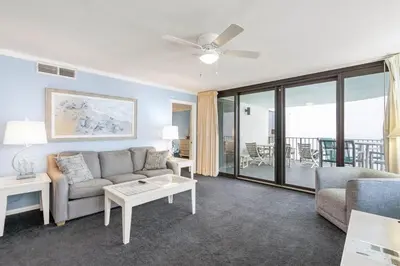 a living room with a couch and a table at Watercrest 1509 - Sleeps 8 Amazing sunsets in Panama City Beach