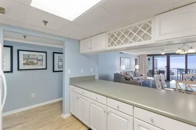 a kitchen and dining room with a view of the ocean at Watercrest 1509 - Sleeps 8 Amazing sunsets in Panama City Beach