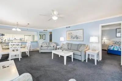 a living room with a couch and a table at Watercrest 1509 - Sleeps 8 Amazing sunsets in Panama City Beach