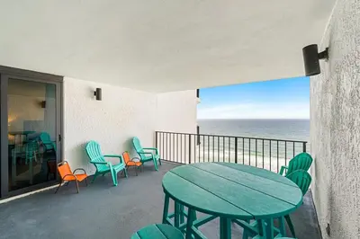 a table and chairs on a balcony with the ocean at Watercrest 1405 - Crystal-Gulf Overlook - Sleeps 8 in Panama City Beach