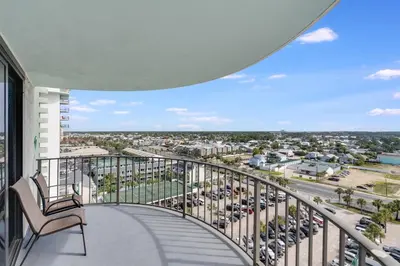 a balcony with a chair and a view of a city at Watercrest 1201 - Swell Life - Sleeps 8 2 BR 2 BA in Panama City Beach