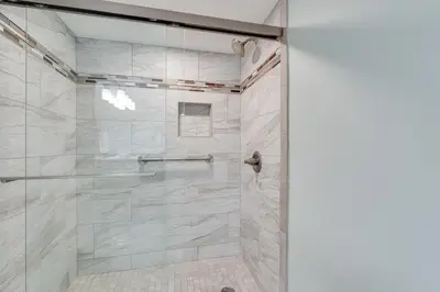 a bathroom with a shower with a glass door at Watercrest 1201 - Swell Life - Sleeps 8 2 BR 2 BA in Panama City Beach