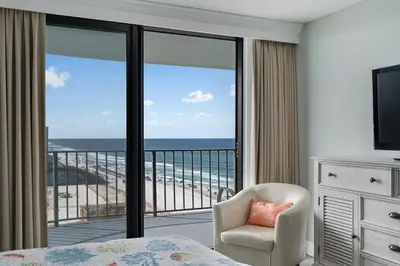 a bedroom with a bed and a balcony with the ocean at Watercrest 1201 - Swell Life - Sleeps 8 2 BR 2 BA in Panama City Beach