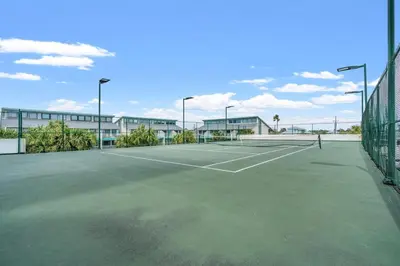 a tennis court in front of a building at Watercrest 207 3 BR 3 BA with 2 Beachfront Masters in Panama City Beach