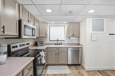 a kitchen with stainless steel appliances and a window at Watercrest 207 3 BR 3 BA with 2 Beachfront Masters in Panama City Beach