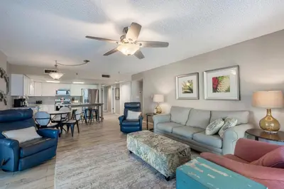 a living room with a couch and a ceiling fan at Watercrest 210- Sleeps 12 - Thomas Drive Retreat in Panama City Beach