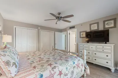 a bedroom with a bed and a ceiling fan at Watercrest 210- Sleeps 12 - Thomas Drive Retreat in Panama City Beach