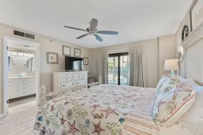 a bedroom with a bed and a ceiling fan at Watercrest 210- Sleeps 12 - Thomas Drive Retreat in Panama City Beach