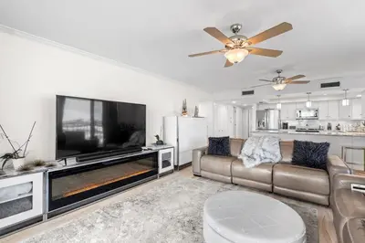 a living room with a large television and a couch at Watercrest 401 Amazing wrap around balcony in Panama City Beach