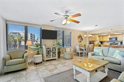 a living room with a couch and a table at Watercrest 209 White-Sands Getaway - Sleeps 8 in Panama City Beach