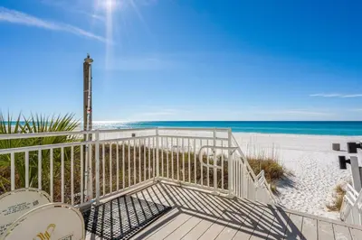a gate to the beach with the ocean in the background at Watercrest 209 White-Sands Getaway - Sleeps 8 in Panama City Beach