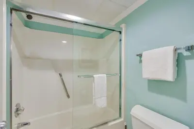 a bathroom with a glass shower stall with towels at Watercrest 203 - Emerald Shore Overlook 2 BR 2 BA in Panama City Beach