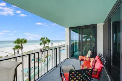 a balcony with chairs and a view of the beach at Watercrest 203 - Emerald Shore Overlook 2 BR 2 BA in Panama City Beach