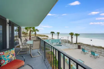 a balcony with a table and chairs and the beach at Watercrest 203 - Emerald Shore Overlook 2 BR 2 BA in Panama City Beach