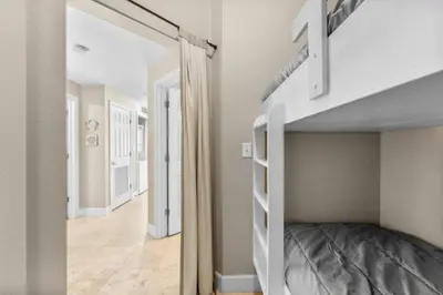 a bedroom with a bunk bed and a hallway at Family-Friendly Gulf-Front Condo w/Beach Access in Panama City Beach