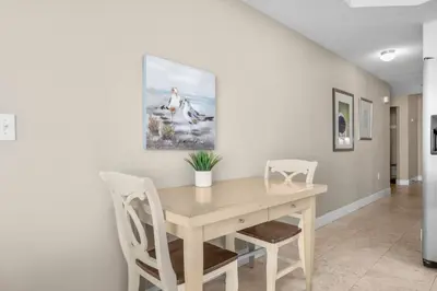a dining room with a wooden table and chairs at Family-Friendly Gulf-Front Condo w/Beach Access in Panama City Beach