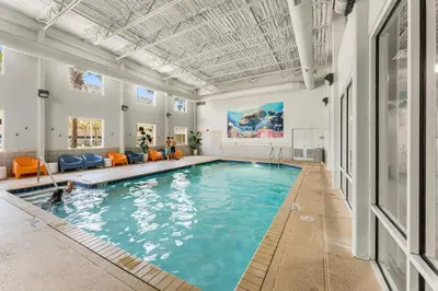 a pool in a building with people in the water at Family-Friendly Gulf-Front Condo w/Beach Access in Panama City Beach