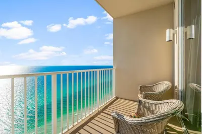 a balcony with two chairs and a view of the ocean at Family-Friendly Gulf-Front Condo w/Beach Access in Panama City Beach