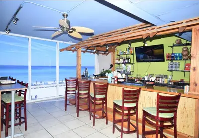a bar with a view of the ocean at Family-Friendly Gulf-Front Condo w/Beach Access in Panama City Beach