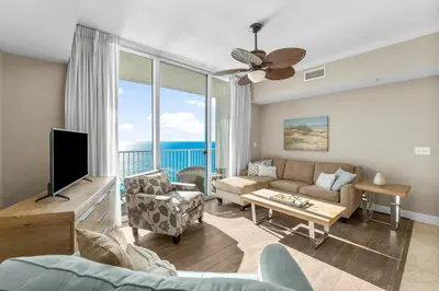 a living room with a couch and a tv at Family-Friendly Gulf-Front Condo w/Beach Access in Panama City Beach