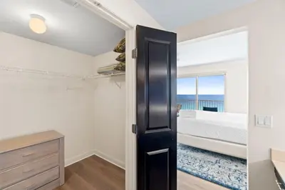 a bedroom with a bed and a large window at Grande Surf Club 11E in Panama City Beach