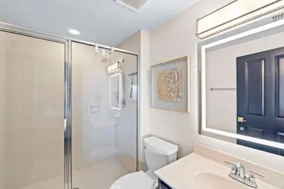 a bathroom with a toilet and a shower and a sink at Grande Surf Club 11E in Panama City Beach