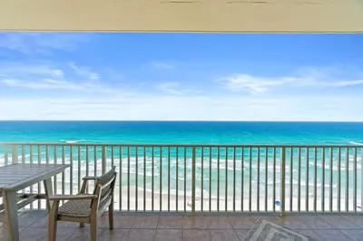 a balcony with a table and chairs and the ocean at Grande Surf Club 11E in Panama City Beach