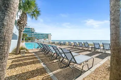 a row of chairs sitting next to the beach at Family-Friendly 4BR Beachfront Retreat w/ Indoor & Outdoor Pools in Panama City Beach