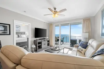 a living room with a couch and a television at Family-Friendly 4BR Beachfront Retreat w/ Indoor & Outdoor Pools in Panama City Beach