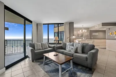 a living room with two couches and a table at Sunbird 407E - Pearl Gulf Getaway - Sleeps 4 in Panama City Beach