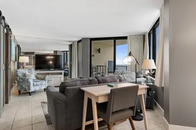 a living room with a couch and a table at Sunbird 407E - Pearl Gulf Getaway - Sleeps 4 in Panama City Beach