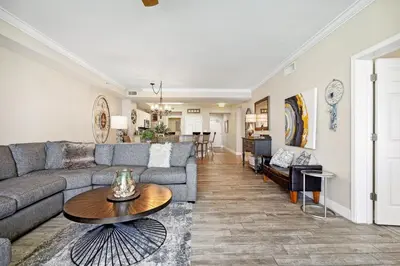 a living room with a couch and a table at Tidewater 2405 - Tidewater Peak Sleeps 6 - 2Br 2Ba in Panama City Beach