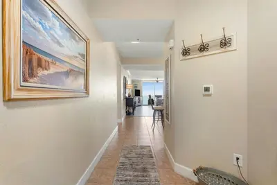 a hallway of a home with a painting on the wall at Tidewater 2405 - Tidewater Peak Sleeps 6 - 2Br 2Ba in Panama City Beach
