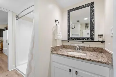a bathroom with a sink and a mirror at Sunbird 110W 1 BR 1 BA Located right next to pool in Panama City Beach