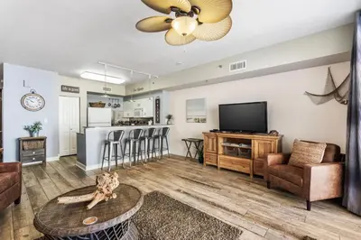 a living room with a couch and a tv at Shores of Panama 926 - Shore-Gulf Peak- 2 BR 2 BA in Panama City Beach