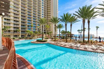 a swimming pool with palm trees and a resort at Shores of Panama 926 - Shore-Gulf Peak- 2 BR 2 BA in Panama City Beach