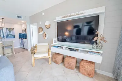 a living room with a flat screen tv on a wall at Sterling Reef 503 - Pierview Oasis - Sleeps 6 in Panama City Beach