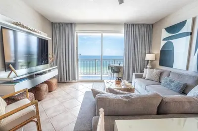 a living room with a couch and a television at Sterling Reef 503 - Pierview Oasis - Sleeps 6 in Panama City Beach