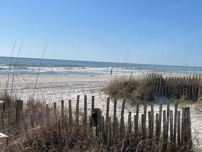 a wooden fence on a beach with the ocean at Horizon South 33D - Sunstead Retreat - Sleeps 6 in Panama City Beach