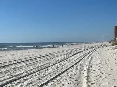 a beach with footprints in the sand and the ocean at Horizon South 33D - Sunstead Retreat - Sleeps 6 in Panama City Beach