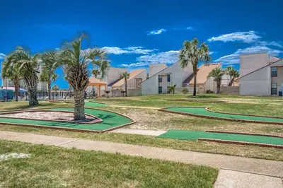 a park with palm trees and golf greens at Horizon South 33D - Sunstead Retreat - Sleeps 6 in Panama City Beach