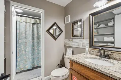 a bathroom with a toilet and a sink and a mirror at Summit 225 - Low floor beachfront - Sleeps 5 in Panama City Beach