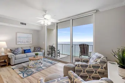 a living room with a couch and chairs and a balcony at Tidewater 2411 - Tidewater Retreat - Sleeps 8 in Panama City Beach