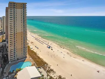 a view of a beach with a building and the ocean at Tidewater 2411 - Tidewater Retreat - Sleeps 8 in Panama City Beach