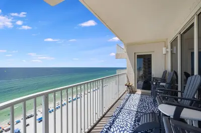 a balcony with chairs and a view of the beach at Shores of Panama 1403 - 3 BR 2 Ba Newly Renovated in Panama City Beach
