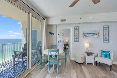 a dining room with a view of the ocean at Shores of Panama 1403 - 3 BR 2 Ba Newly Renovated in Panama City Beach