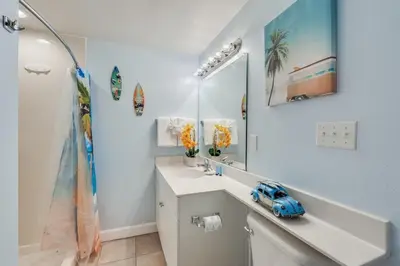 a bathroom with a sink and a mirror at Shores of Panama 1403 - 3 BR 2 Ba Newly Renovated in Panama City Beach