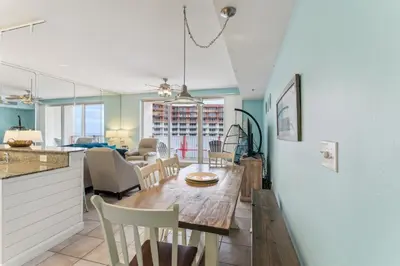 a kitchen and dining room with a table and chairs at Peak-Shore Overlook - Sleeps 8 in Panama City Beach